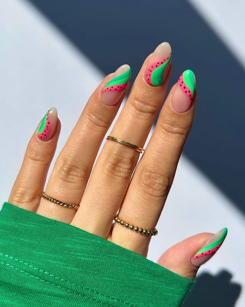 Abstract watermelon nail designs are on-trend.