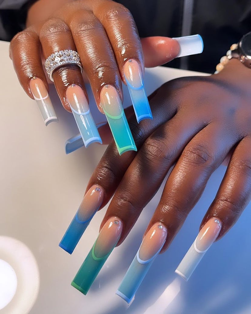 Fluorescent blue invisible French tip nails are on-trend.