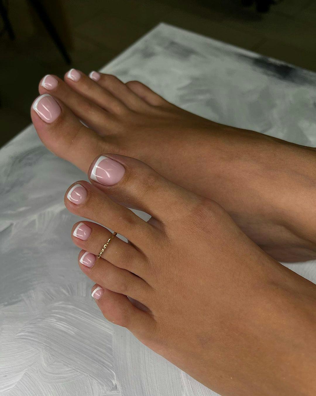 Micro French tip pedicures are on-trend for Taurus season 2024.