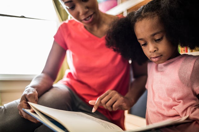 A woman reads with her daughter.