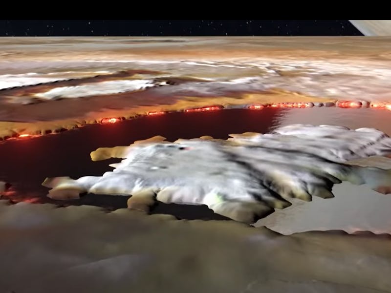 Aerial view of a large volcanic crater with molten lava and smoke, against a backdrop of rugged terr...