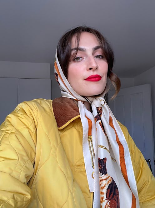 Rio in a headscarf and yellow quilted jacket