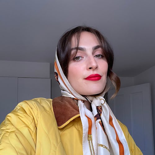 Rio in a headscarf and yellow quilted jacket