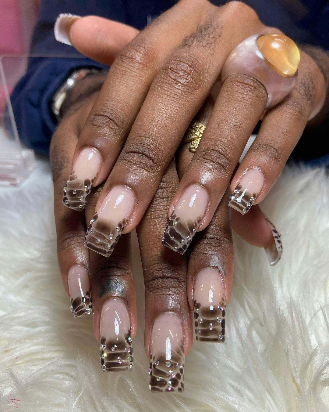 Try chocolate brown crocodile print French tip nails.