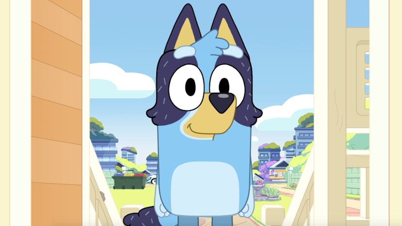 Bluey stands in the doorway of her parents' house.
