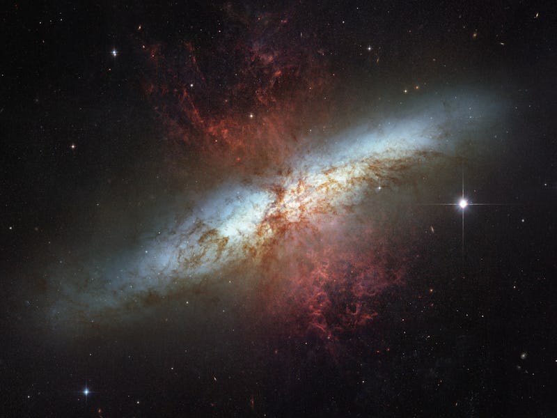 A vibrant photo of a spiral galaxy with swirling arms of stars and cosmic dust, set against the dark...