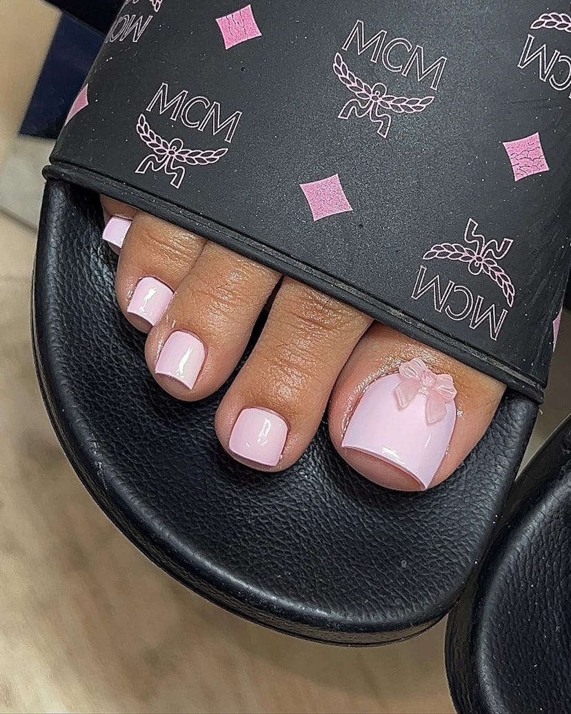 Try a pastel pink pedicure with a 3D ribbon adornment.