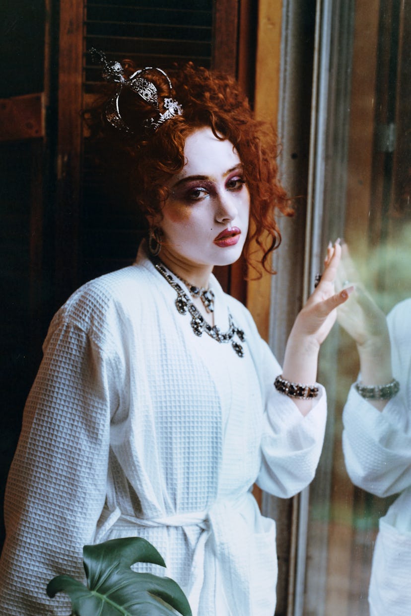 Chappell Roan wears a white bathrobe with maximalist jewelry and full glam