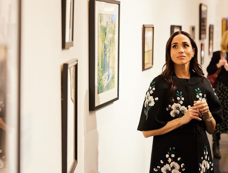 Meghan Markle in a Carolina Herrera cape.