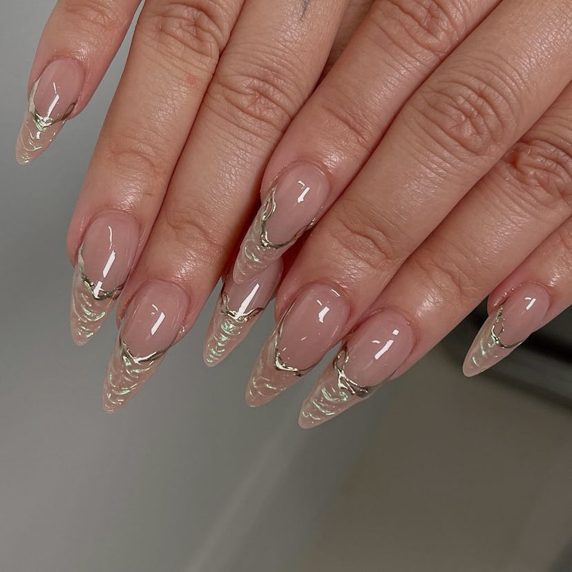 Out-there 3D French tip nails with a holographic finish are perfect for Aquarius signs.