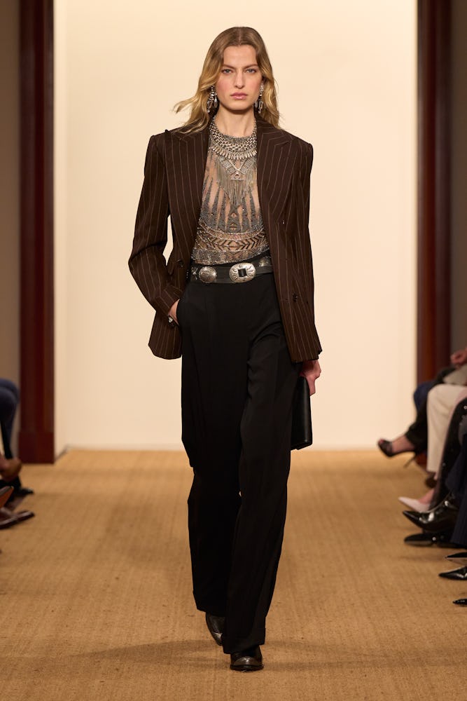 model wearing pinstripe blazer, embellished blouse, black trousers on ralph lauren fall holiday 2024...