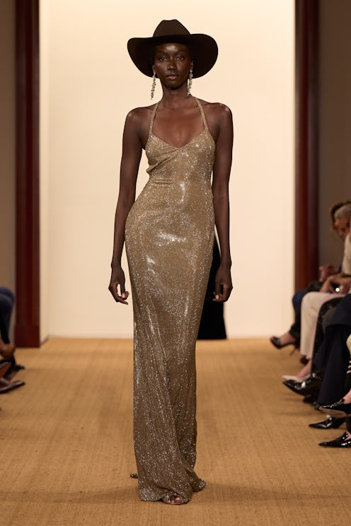 Anok Yai in a cowboy hat and shiny dress on Ralph Lauren runway