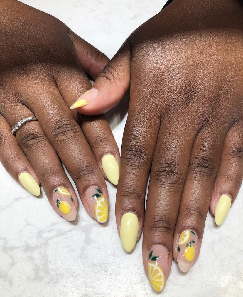 Nails with lemon designs are trending for summer 2024.