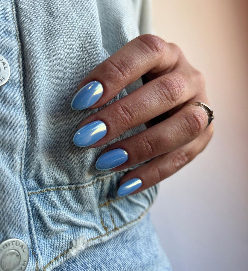 Pastel blue chrome nails are trending for summer 2024.