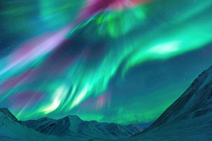 Aurora Borealis (Northern Lights) exploding over the Alaskan peaks near Atigun Pass along the Dalton...