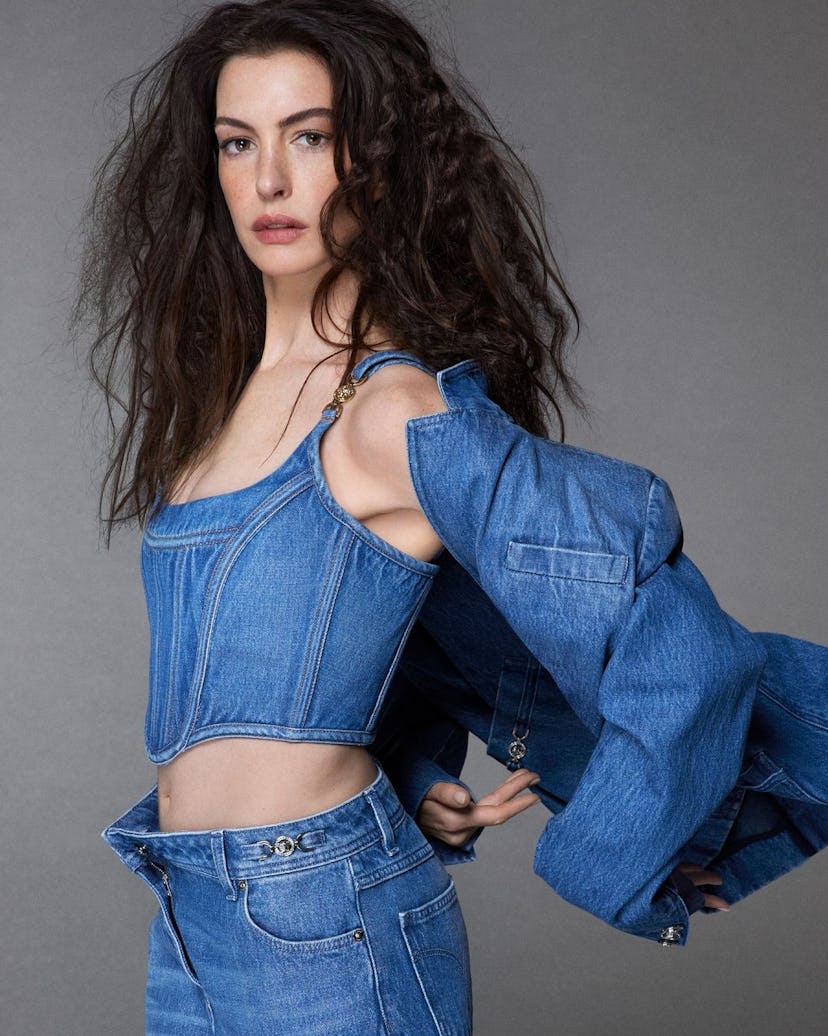 Anne Hathaway wears a denim bustier top in Versace's Icons campaign.