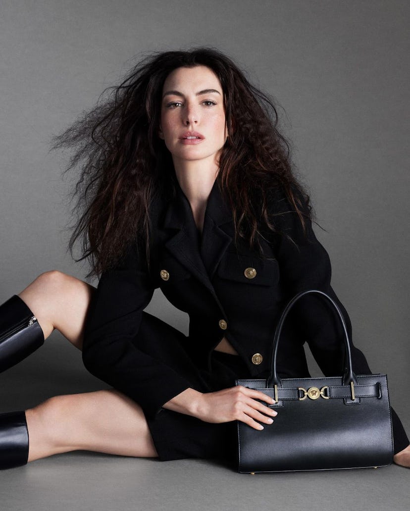 Anne Hathaway wears a skirt suit in Versace's Icons campaign.