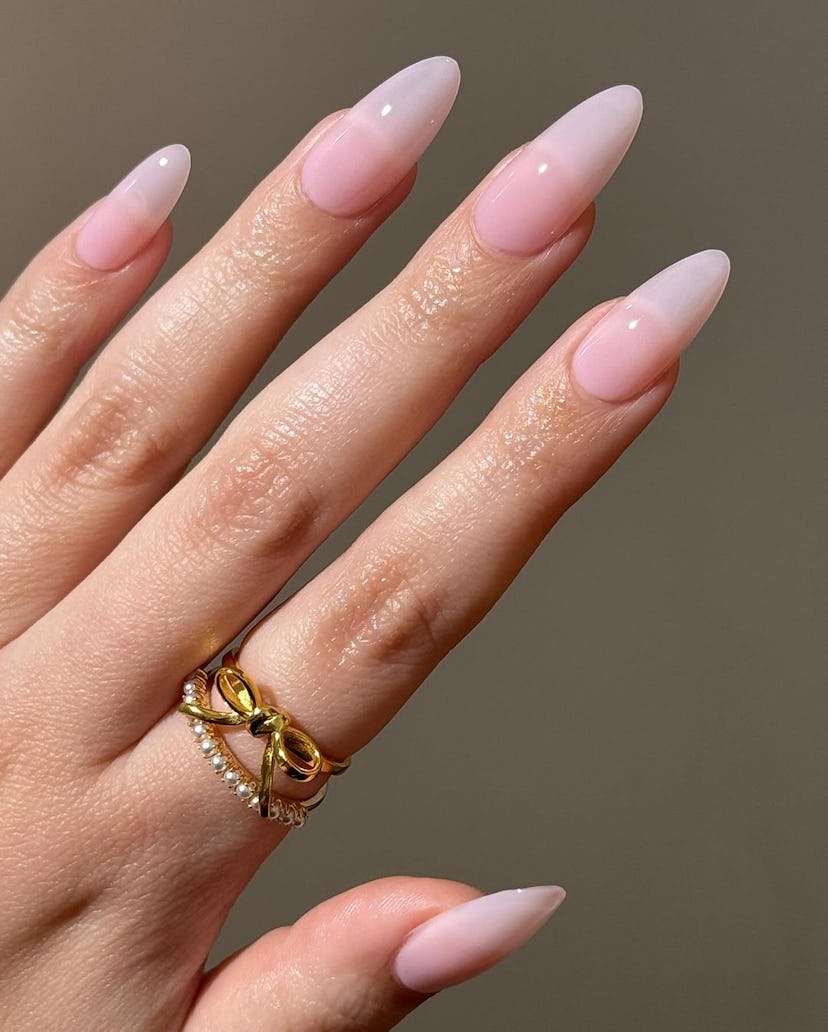 Sheer pink nail polish is on-trend for summer 2024.