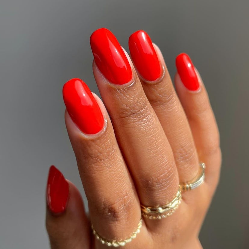 Red-hot coral nail polish is on-trend for summer 2024.