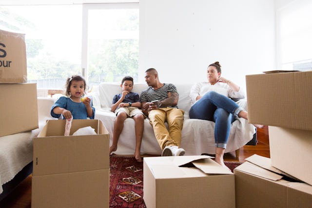 A family unpacks boxes in their new home.