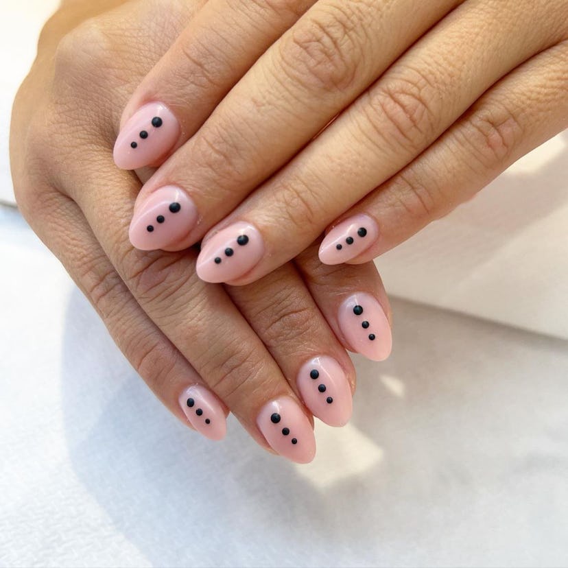 Try minimal nails with bold black dot designs.