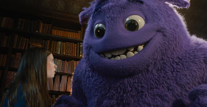 A young girl looks skeptically at a giant, smiling, friendly-looking monster.