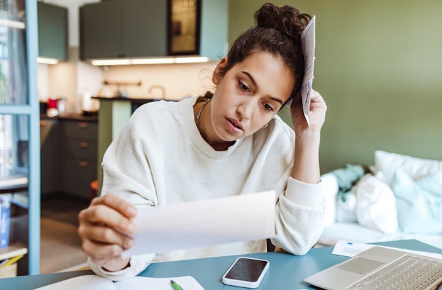 A woman stresses over bills.