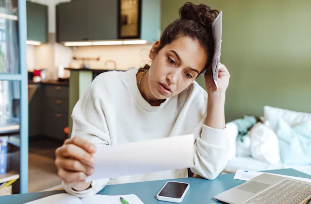 A woman stresses over bills.