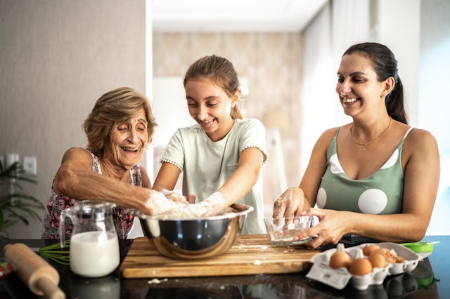 A grandmother, granddaughter, and mother bake together.