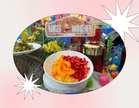 A comic-themed display featuring a bowl of colorful cereal with various snacks and vibrant decoratio...