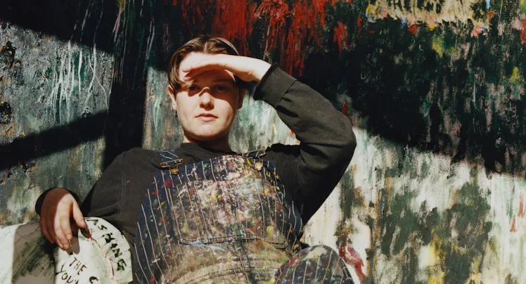 Daisy Parris sitting in their studio