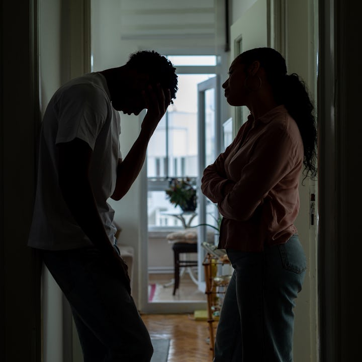 A couple fights in the hallway of their home.