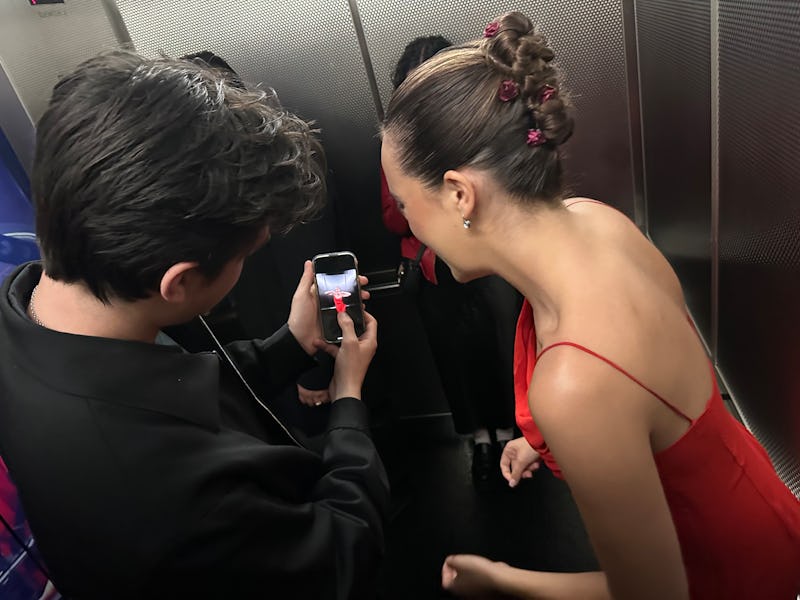Bailee Madison takes pictures in the elevator after the 'Pretty Little Liars' screening. 