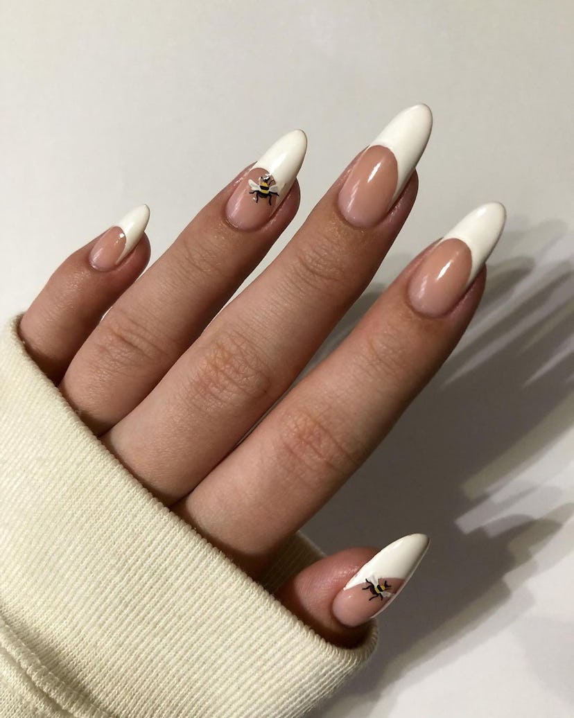 These French tip nails with bumblebee art are inspired by ‘Bridgerton.'