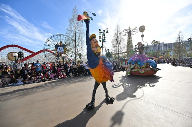 Russell rides Kevin in front of Carl from the movie Up during the "Better Together: A Pixar Pals Cel...