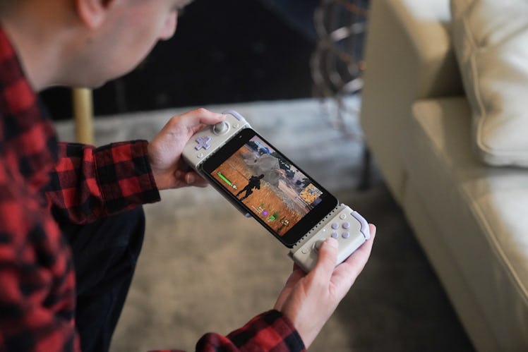 Inverse editor James Pero holding a GameSir X2s mobile gaming controller.