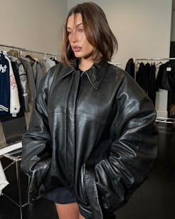hailey bieber wears a black leather bomber jacket