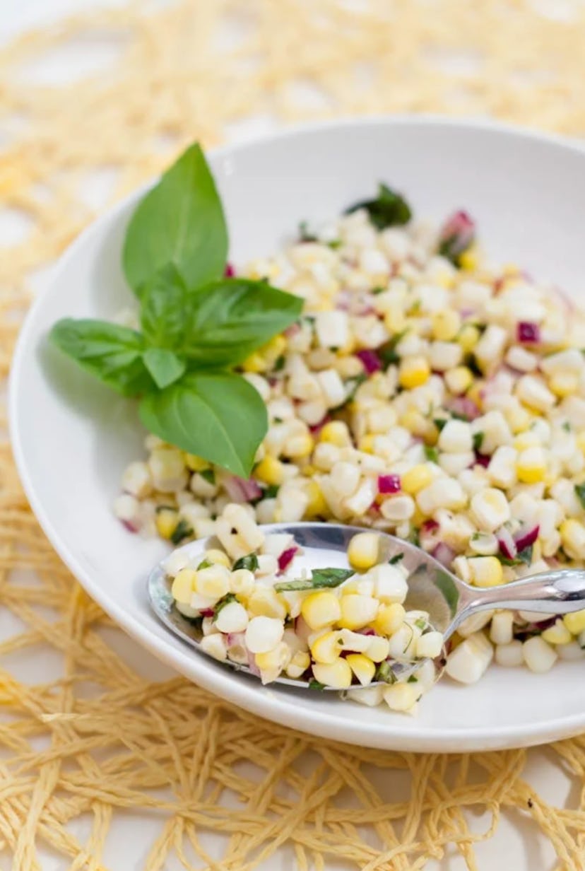 One make-ahead cookout side is this fresh corn and basil salad.