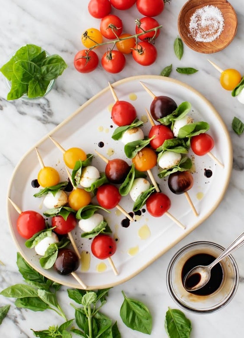 One make-ahead cookout side are caprese skewers.