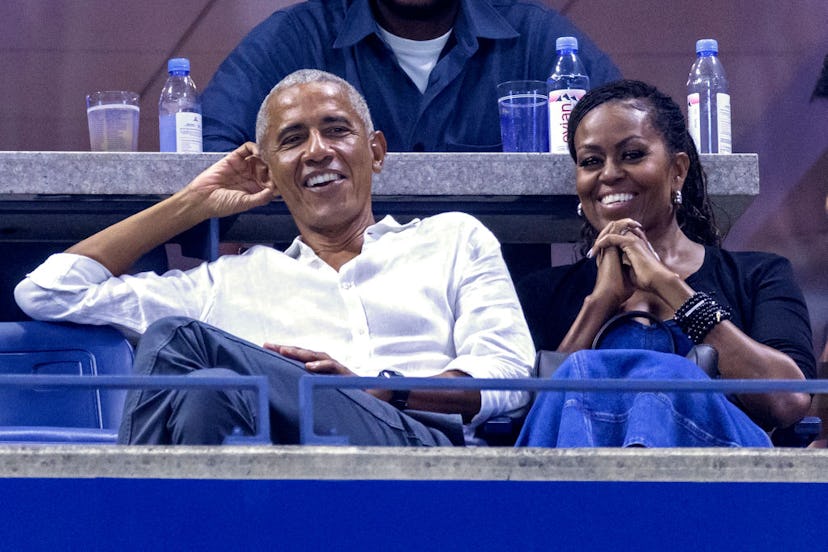 Former US President Barack Obama (L) and his wife former US First Lady Michelle Obama (R) attend the...