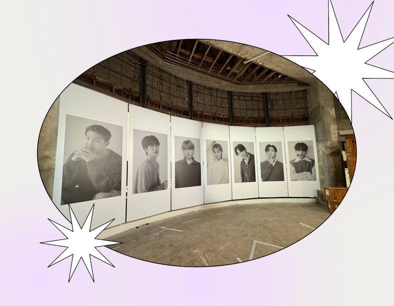 An exhibition with large photographs of men displayed in a curved format inside an industrial-style ...