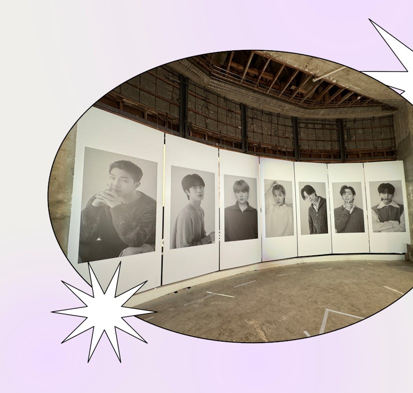 An exhibition with large photographs of men displayed in a curved format inside an industrial-style ...