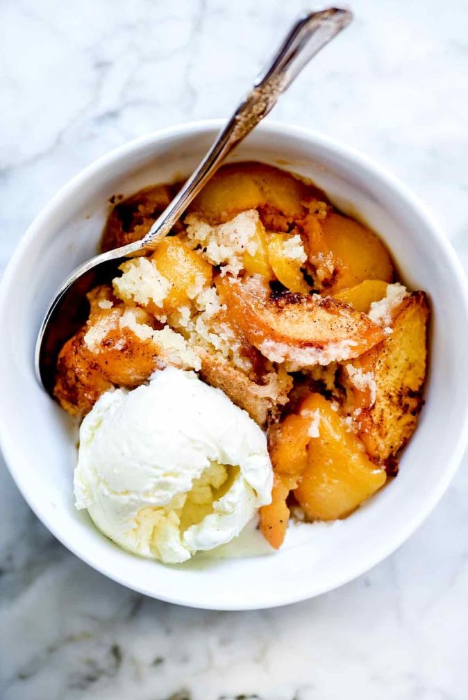Peach cobbler is one of the tastiest summer desserts to make, served with vanilla ice cream.