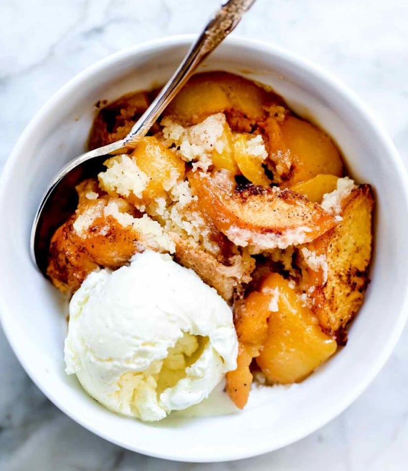 Peach cobbler is one of the tastiest summer desserts to make, served with vanilla ice cream.