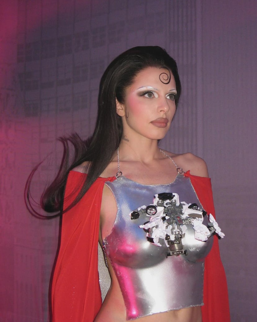 Julia Fox wore a silver breastplate outfit with a cape and thigh high boots to film OMGFashun! in Ne…