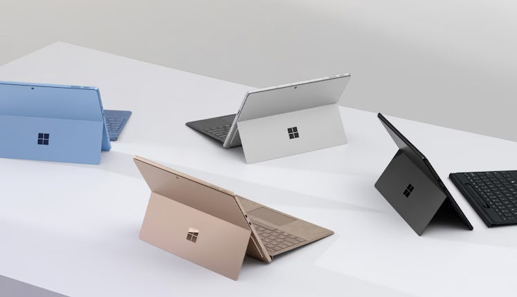 Multiple new Surface Pros sitting on a table.
