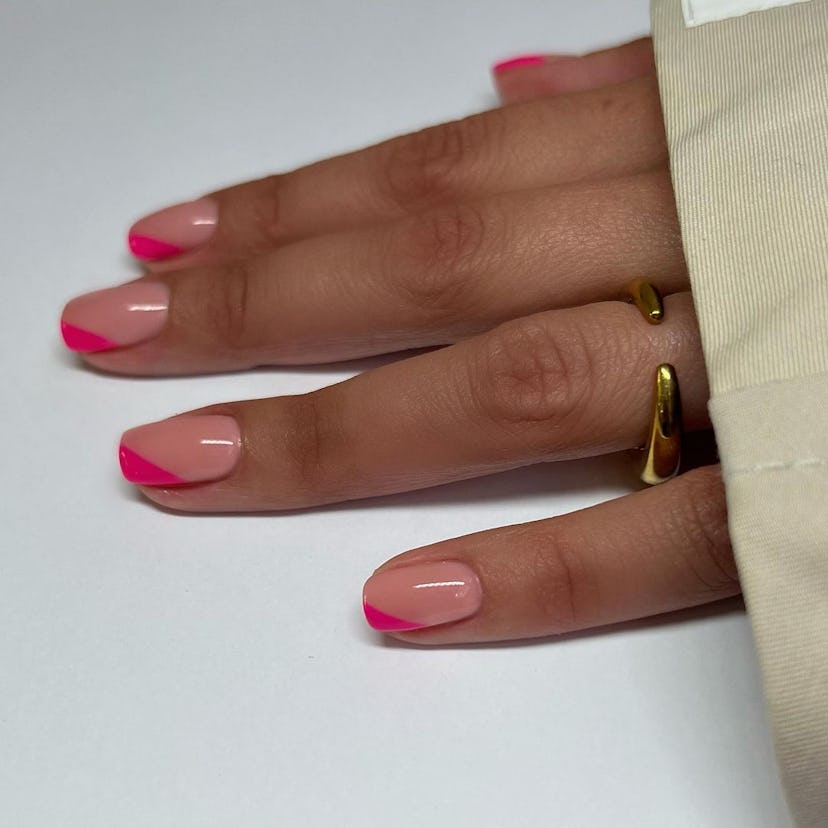 Hot pink angled French tip nails are on-trend for summer 2024.