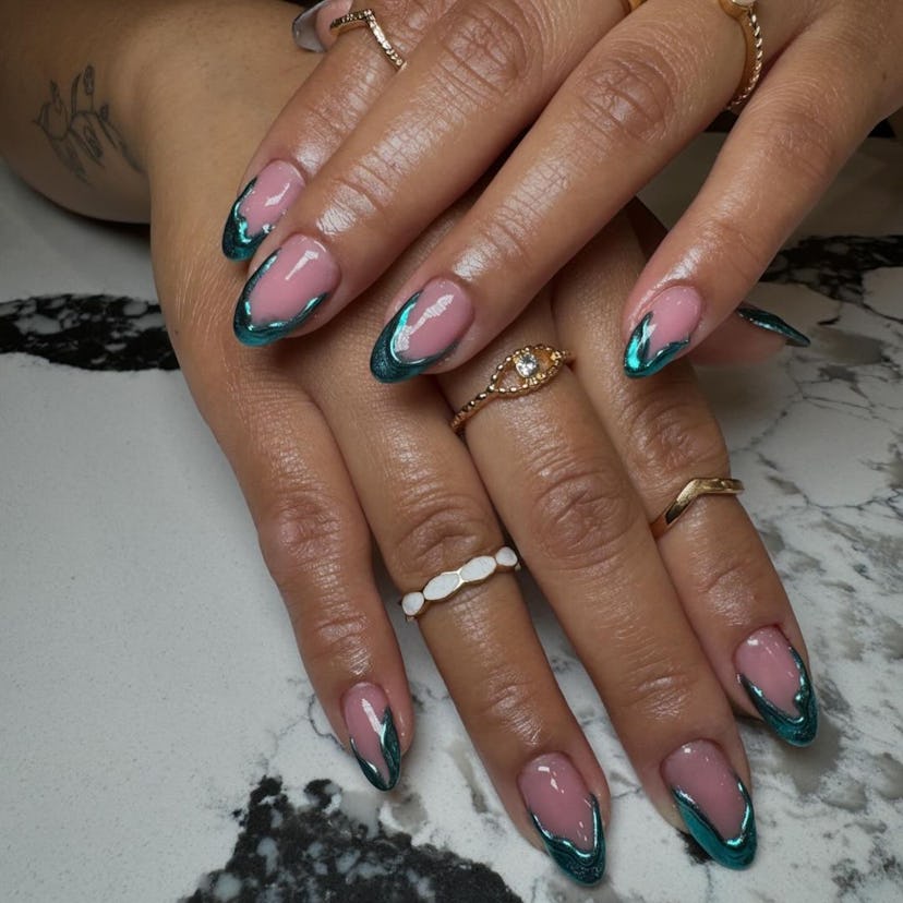 Abstract aquamarine French tip nails are on-trend for summer 2024.