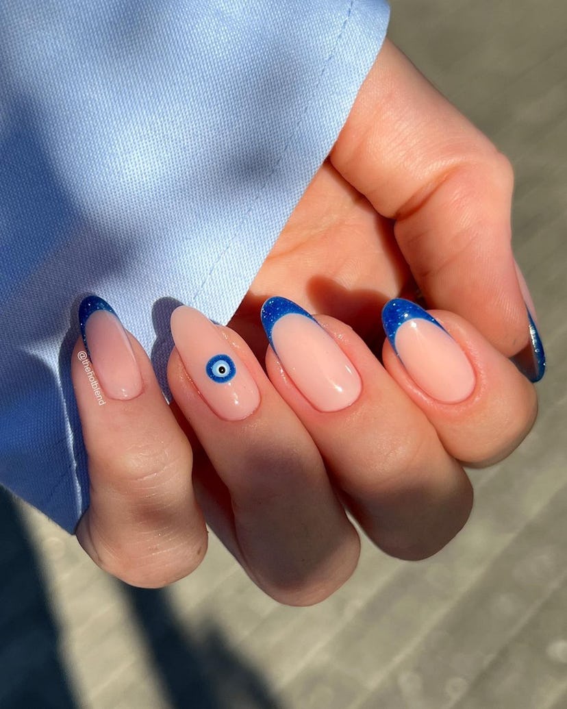 French tip nails with evil eye details are on-trend for summer 2024.