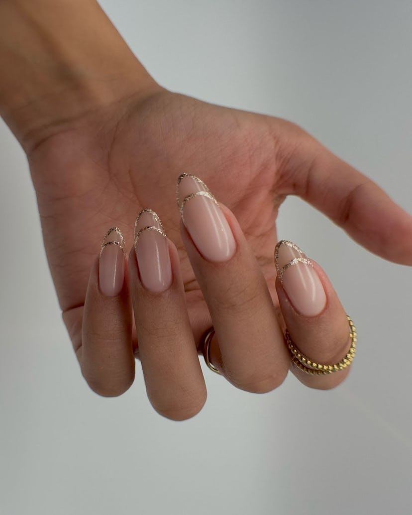Gold outlined French tip nails are on-trend for summer 2024.